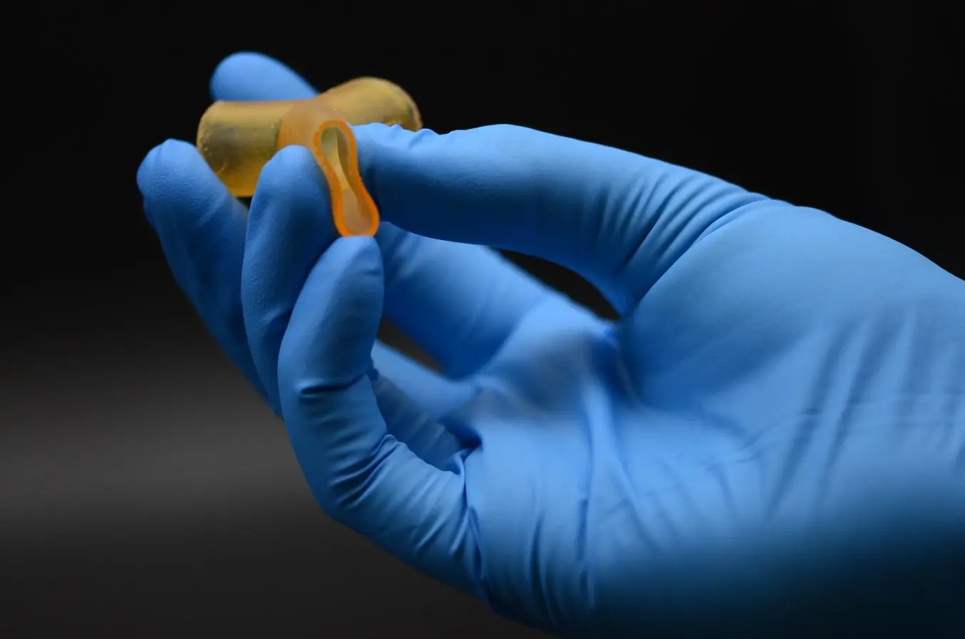 A hand holding a SLA 3D printed part